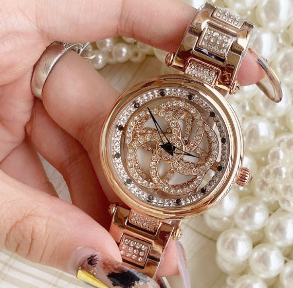 Foreign trade hot style watch female steel watch lady quartz watch to turn the windmill surface douyin the same