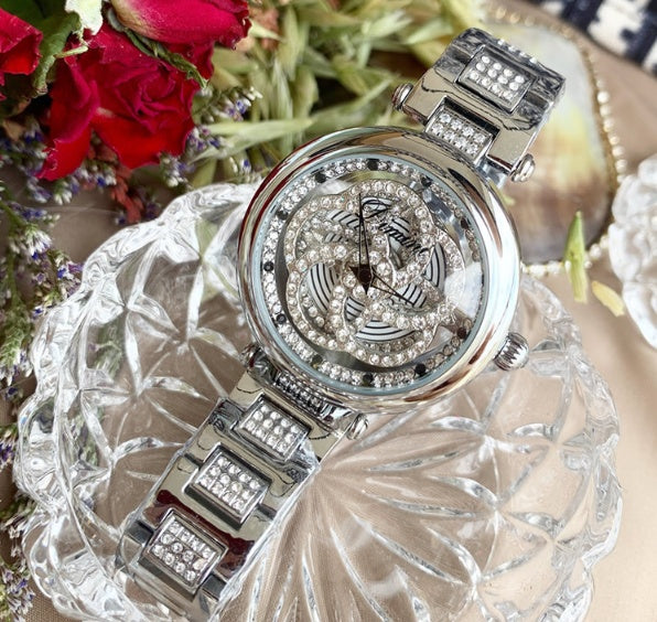 Foreign trade hot style watch female steel watch lady quartz watch to turn the windmill surface douyin the same